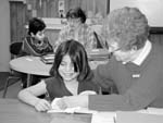 Adult working with student