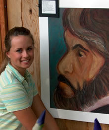 student standing in front of art