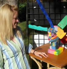 student standing in front of art