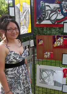 student standing in front of art