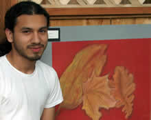 student standing in front of art