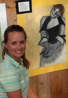 student standing in front of art