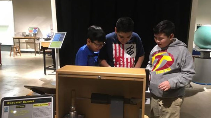 Students looking at museum display