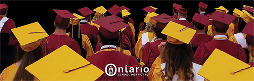 Graduating students in cardinal and corn cap and gowns